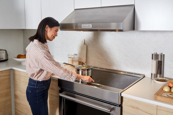 A woman uses her clean electric stove
