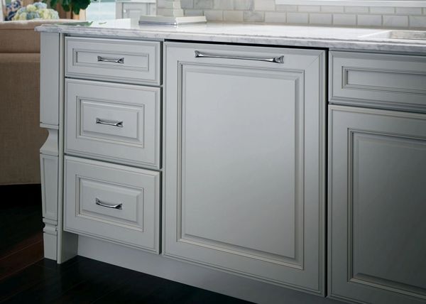 The Monogram ZDT985SINII panel ready dishwasher with a matching white cabinet front panel