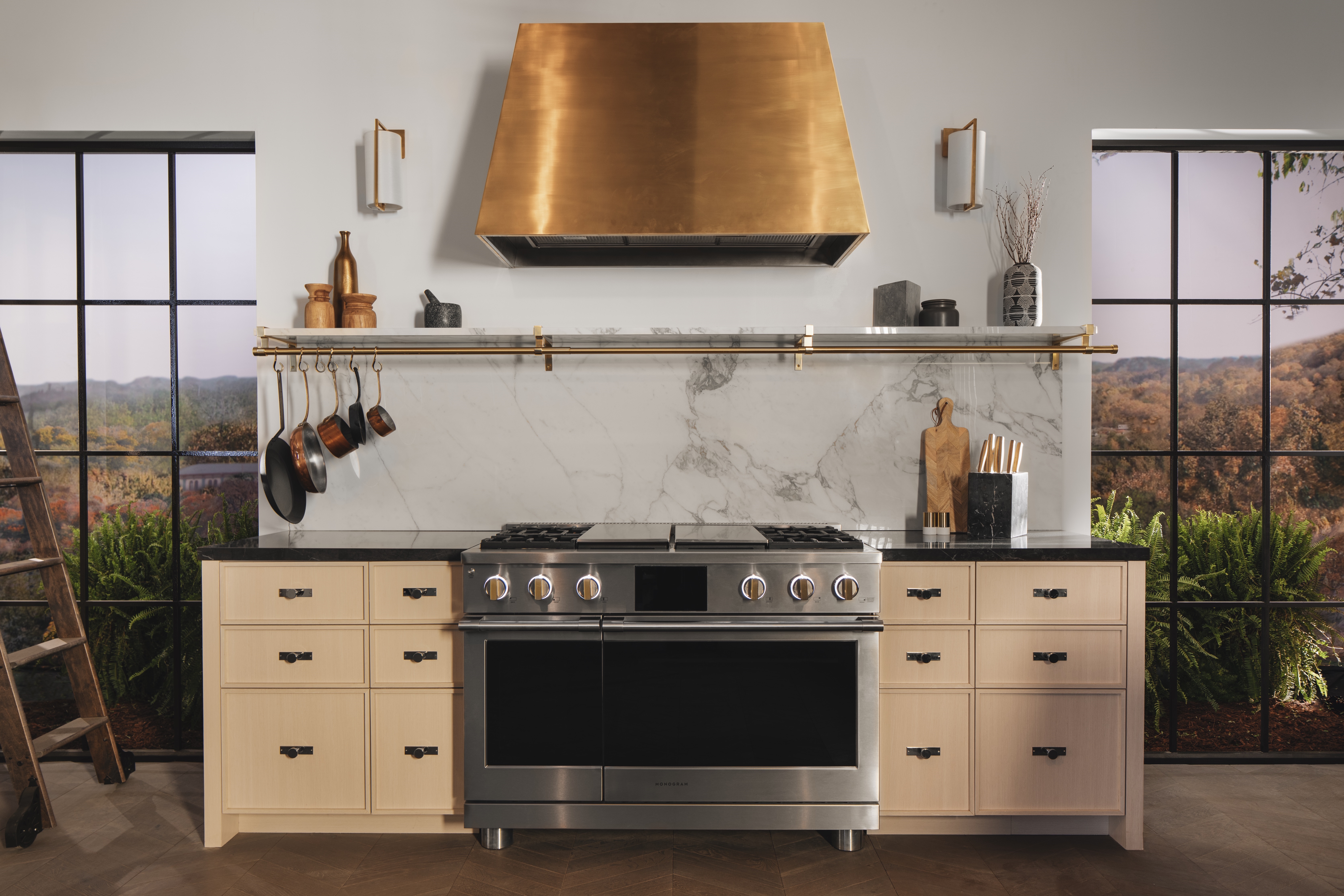 Head on shot of kitchen featuring Monogram pro range 