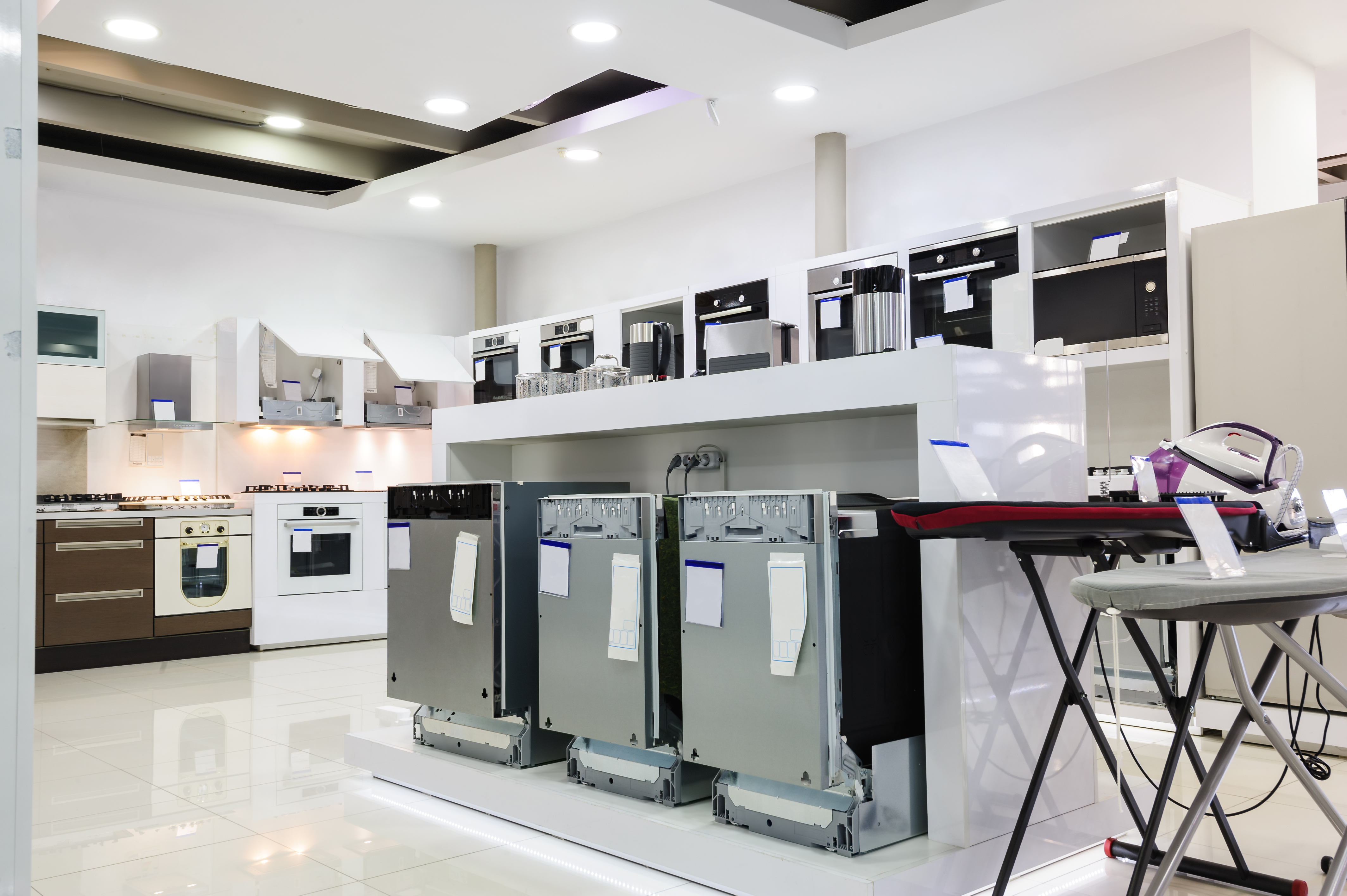 Several dishwashers on sale on an appliance showroom floor 
