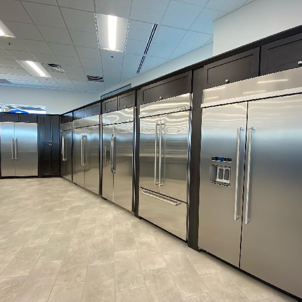 A variety of built-in refrigerators on a Spencer’s TV & Appliance showroom floor 