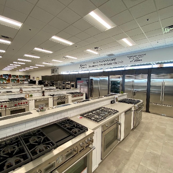 A variety of cooking appliances on a Spencer’s TV & Appliance showroom floor 