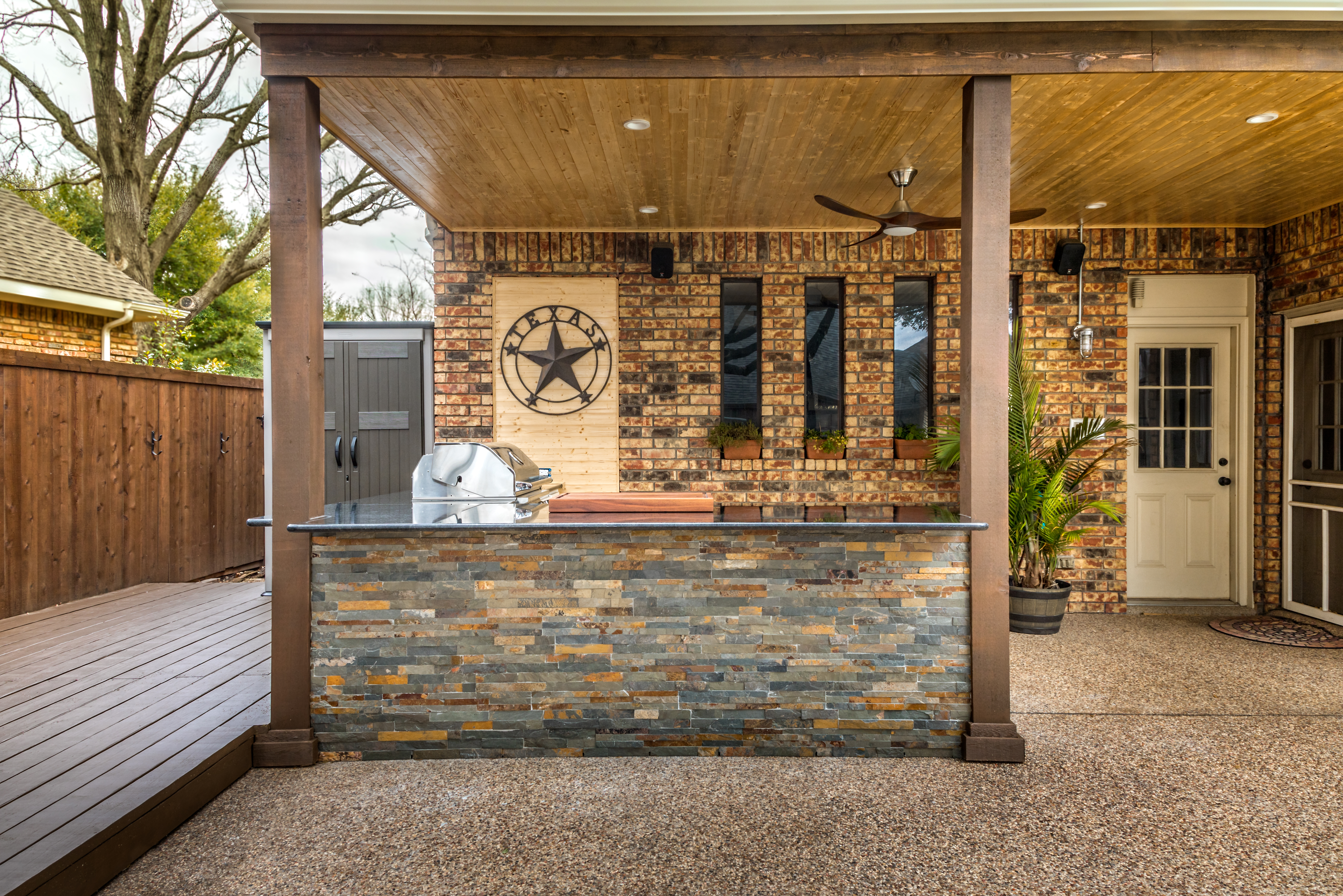 Wide shot of two bar stools in a Southwest-style outdoor kitchen 