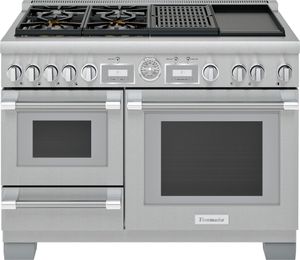 Stainless steel Thermador brand range with two ovens and a warming drawer. 
