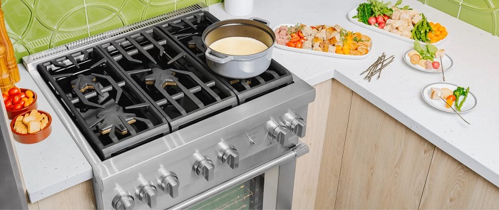 Overhead shot of a modern kitchen with a Thermador brand range and fondue arrangement on the stove and counters. 