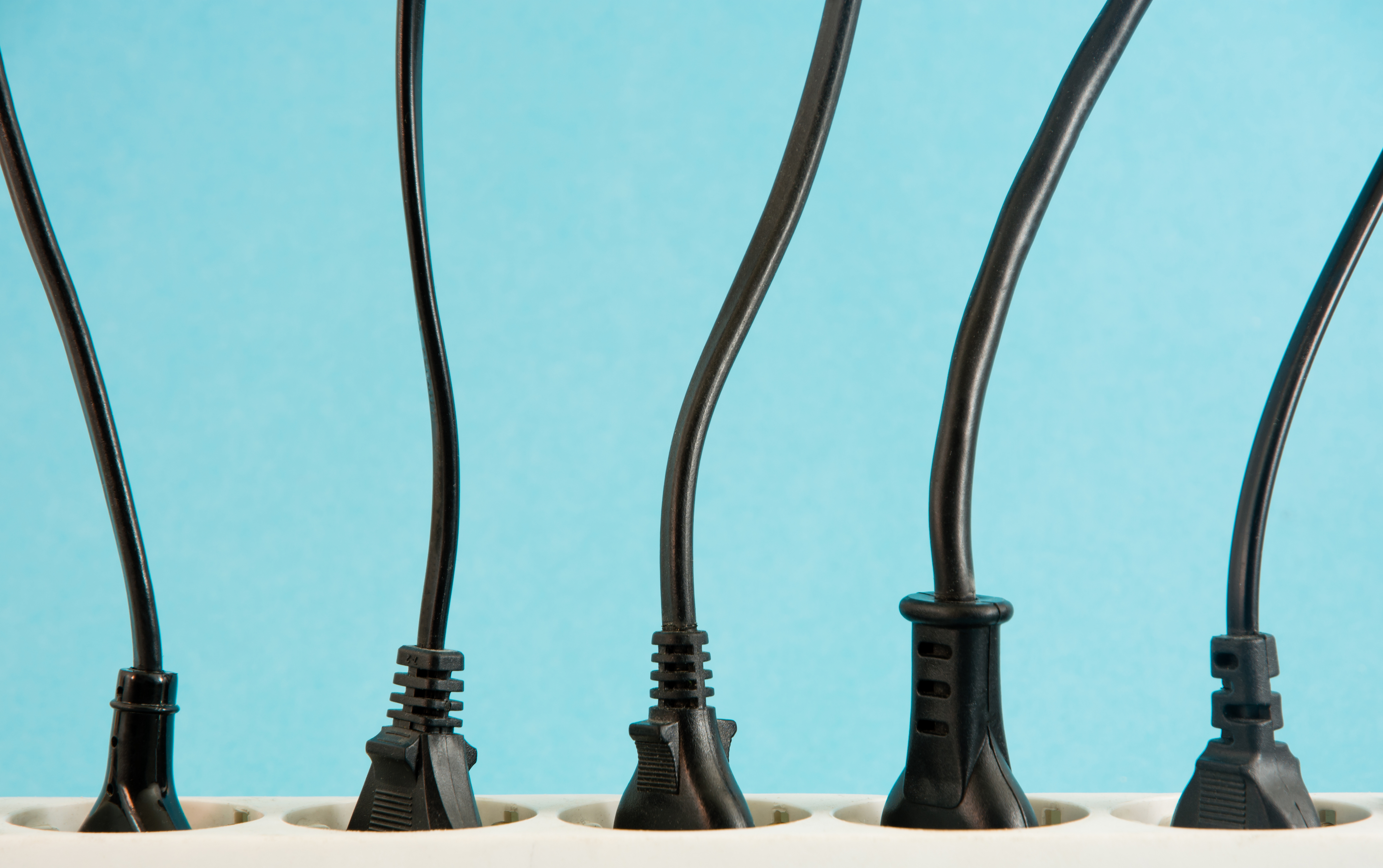 A power strip with plugs against a blue background 