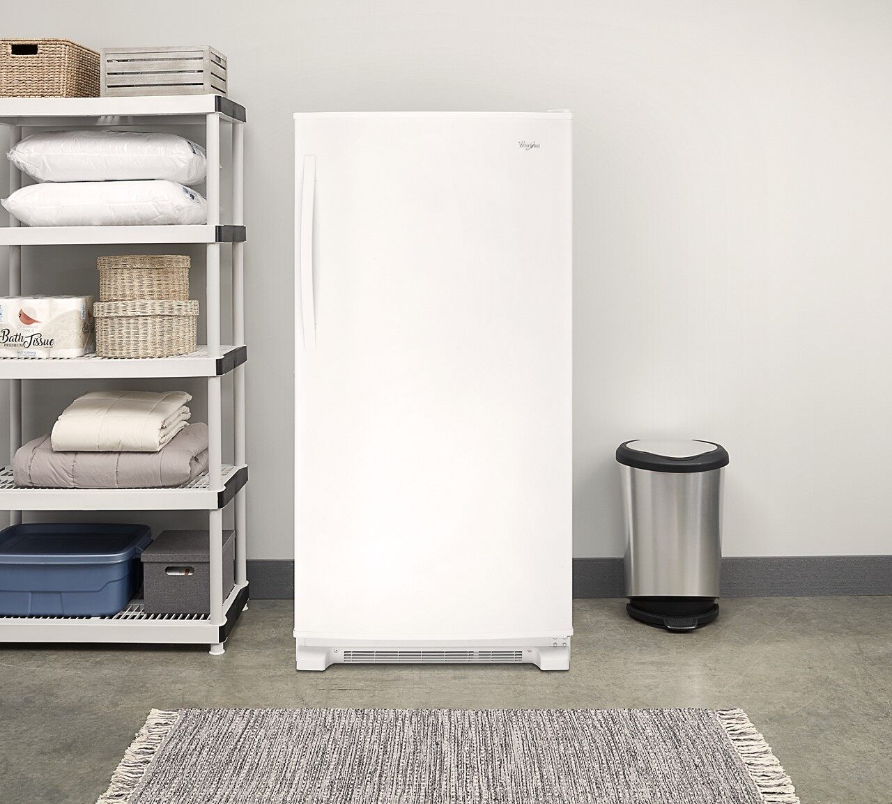 Garage laundry area featuring Whirlpool wzf79r20dw upright freezer