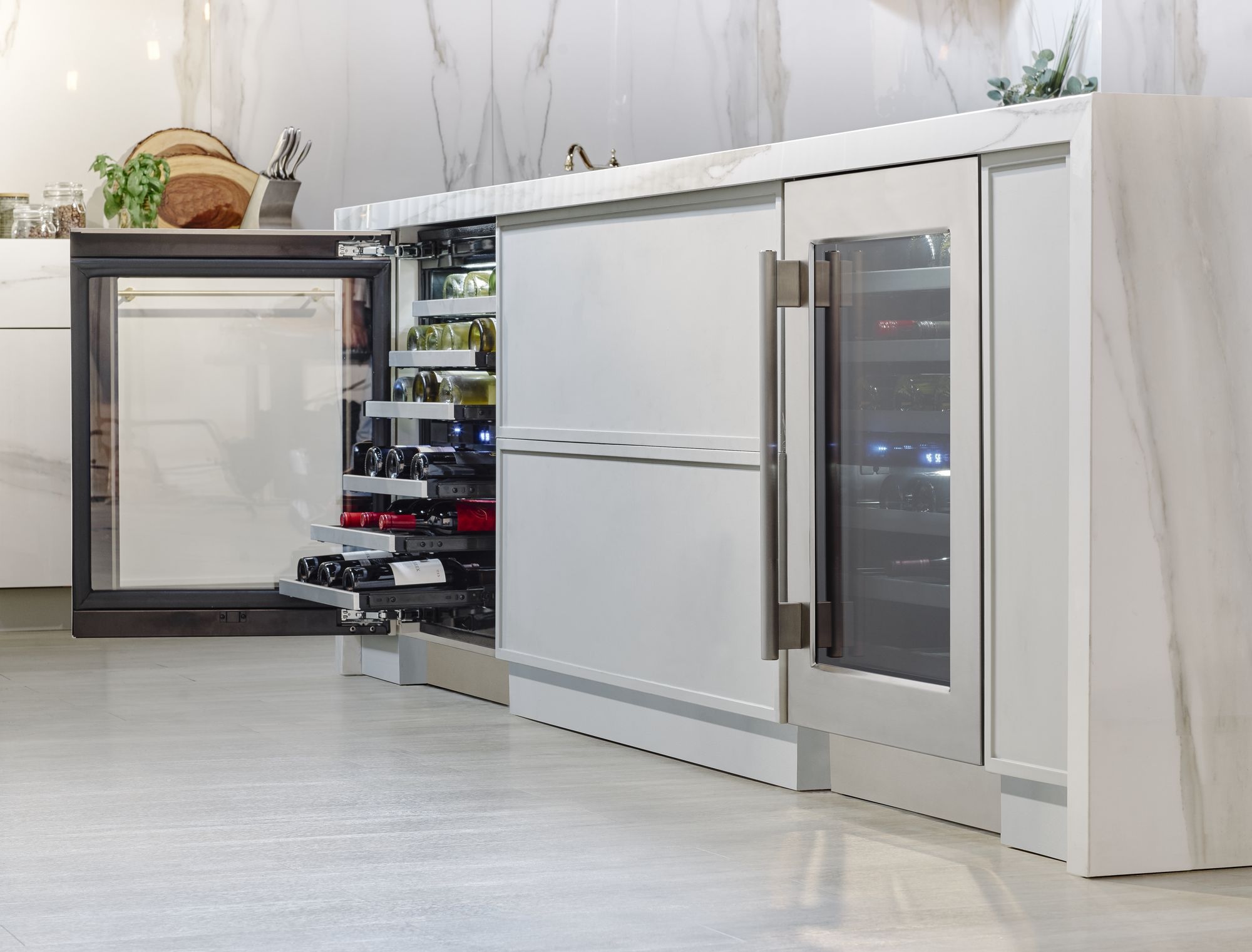 Thermador stainless-steel wine cooler with pulled-out drawers in kitchen island