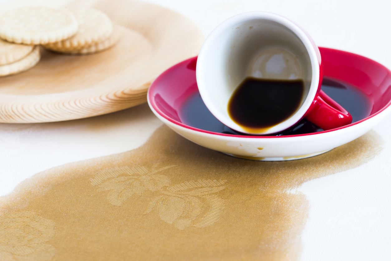 spilled coffee on white tablecloth 