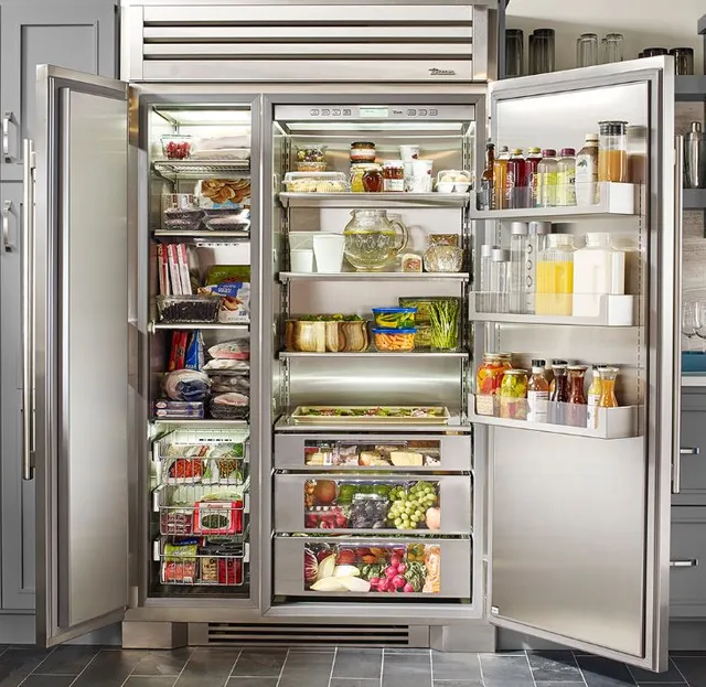 A True built in refrigerator with doors ajar