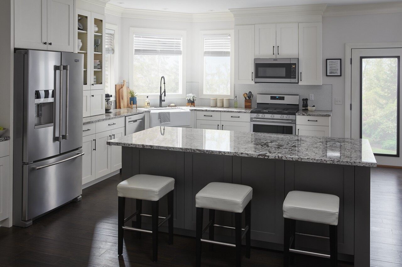 A kitchen featuring a Maytag refrigerator, range, and microwave 