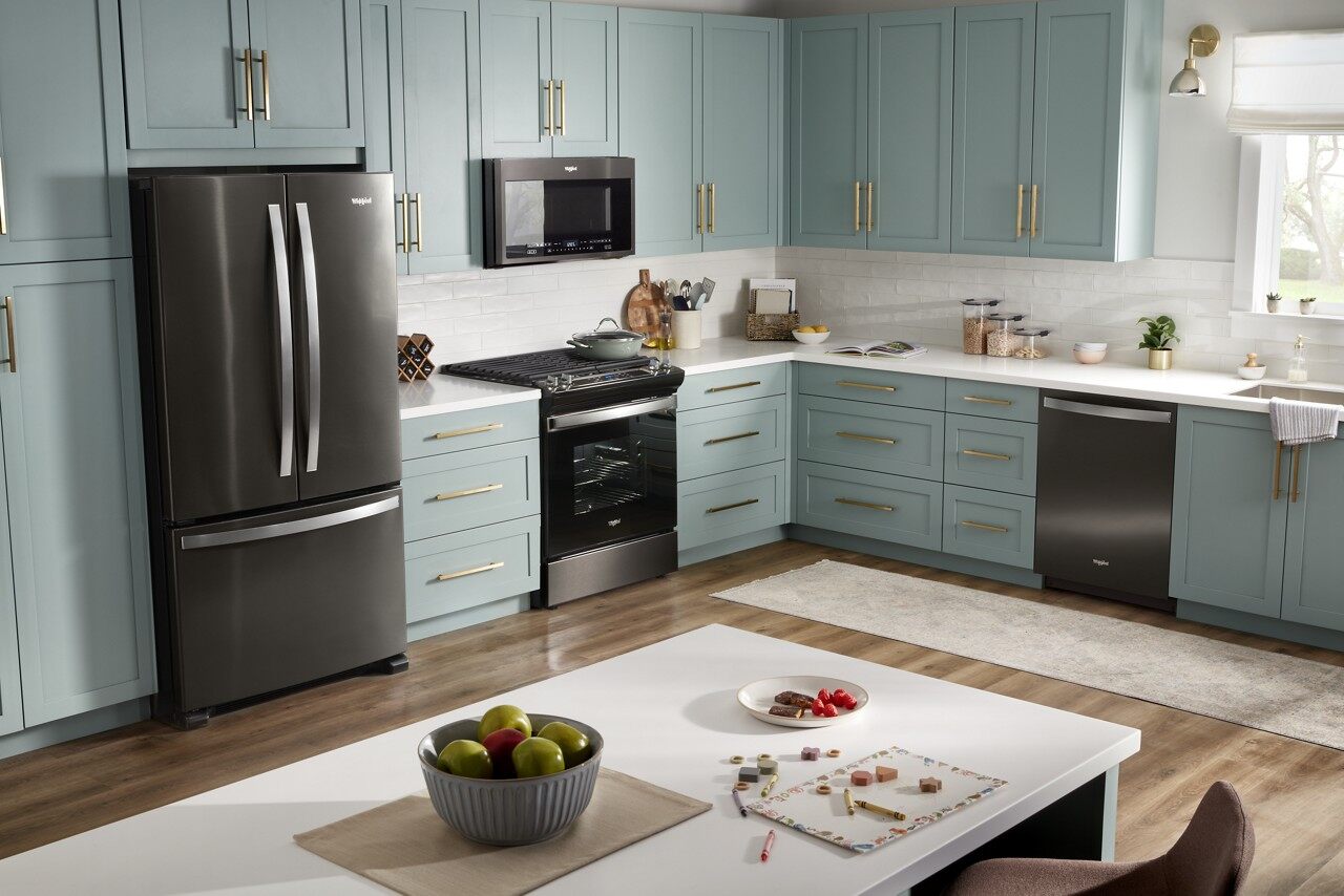 Kitchen featuring a Whirlpool refrigerator, range, dishwasher, and microwave 