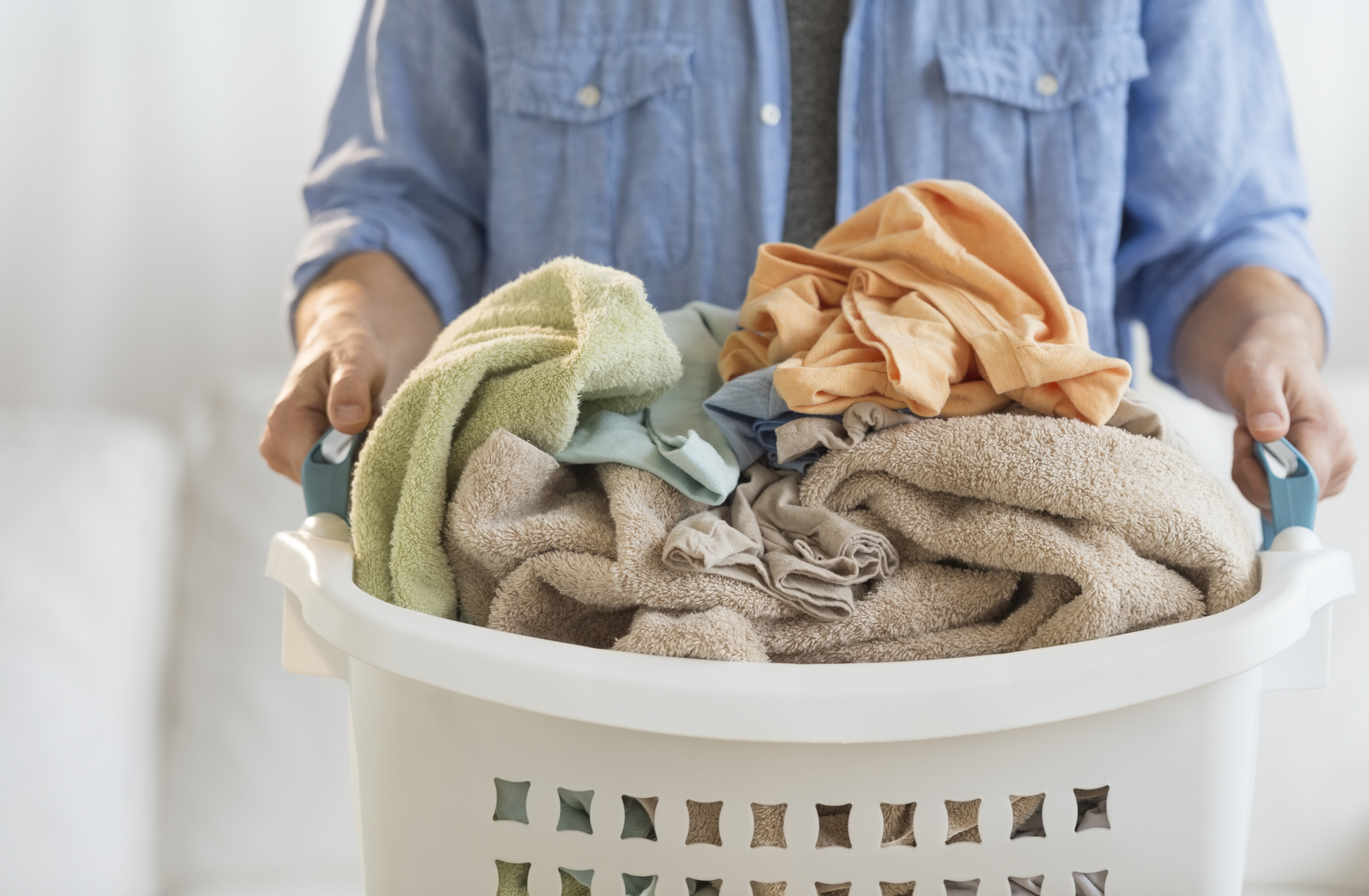 man holding laundry basket