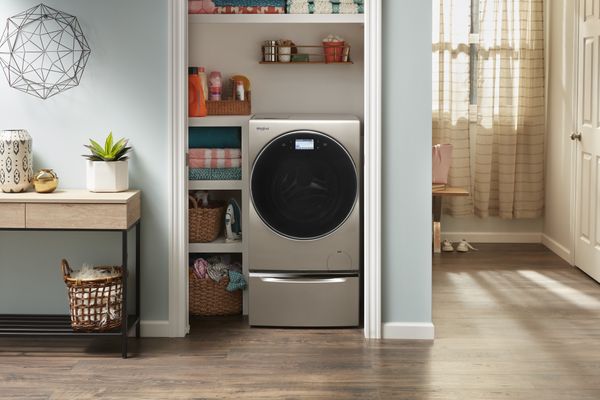 A Whirlpool washer dryer combo in a closet