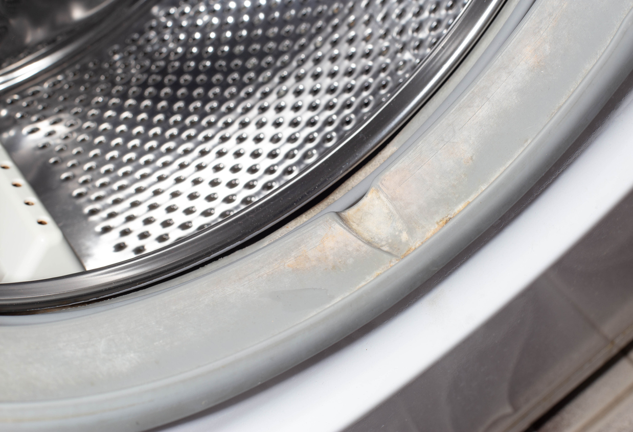 closeup of front-loading washer drum with limescale buildup