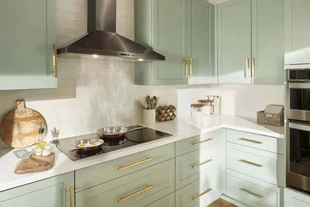 Front view of a modern kitchen with a black Whirlpool electric cooktop and range hood.