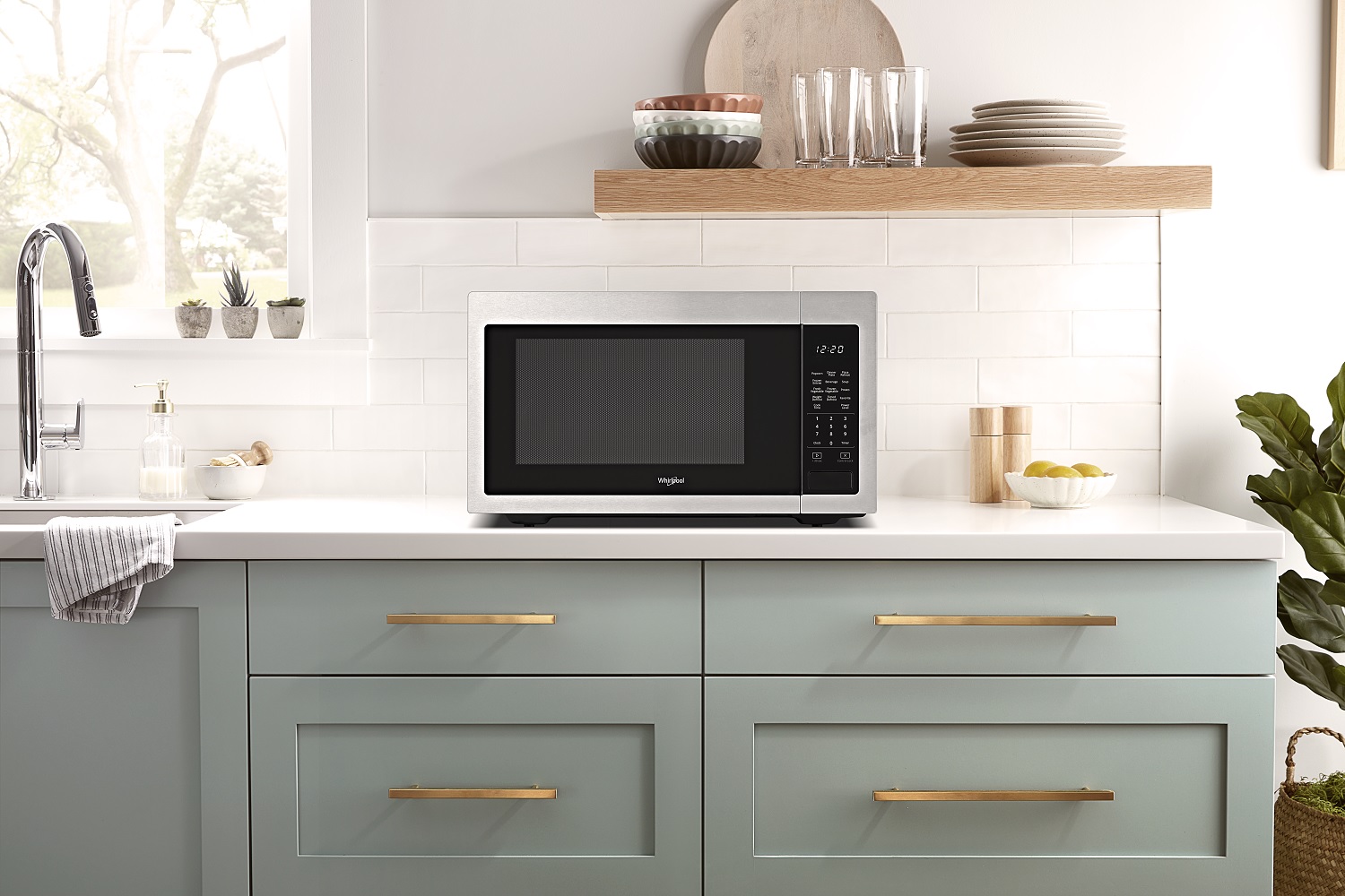 Whirlpool stainless steel countertop microwave over clean counter