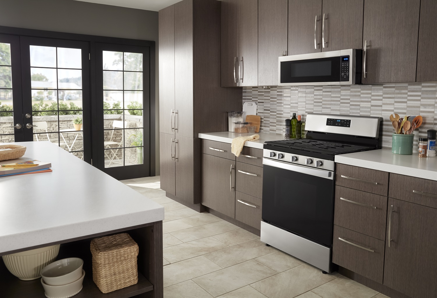 Whirlpool stainless steel freestanding range under Whirlpool over-the-range microwave