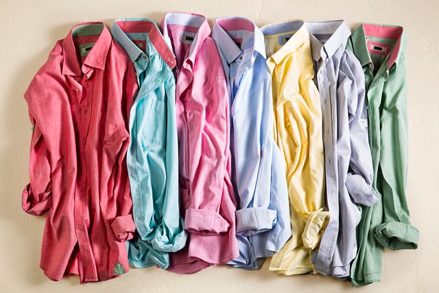 men's dress shirts in various pastel colors laying in an orderly line