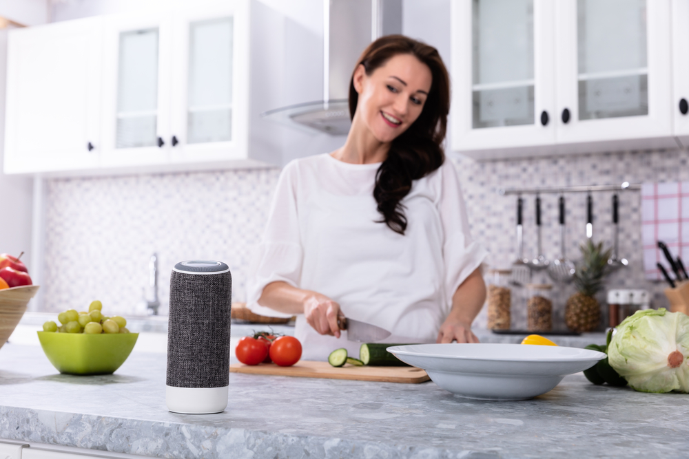 a woman in her kitchen with her voice activated smart home system