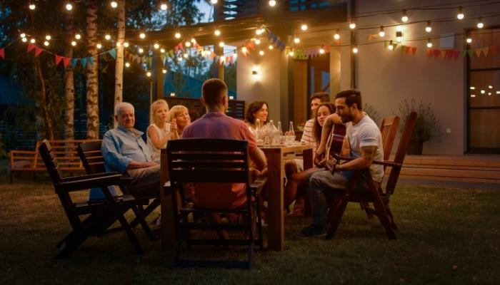 Family eating together on the back patio at night