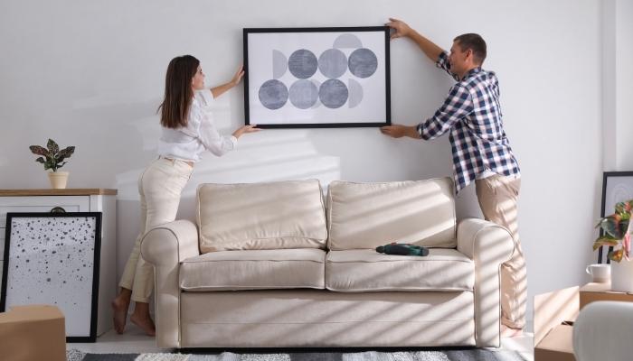 Couple installing picture frame
