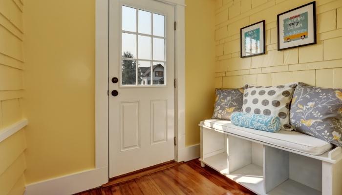 One of the best ways to save space in the entryway is to add a bench with storage.