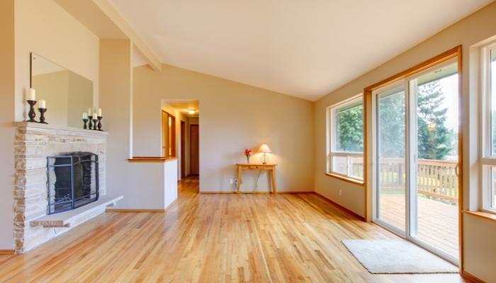 Empty room with sliding glass doors, wood floors, and fireplace