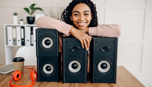 Woman Leaning on Speakers