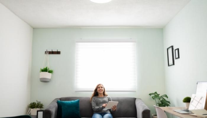 Woman controlling light with tablet