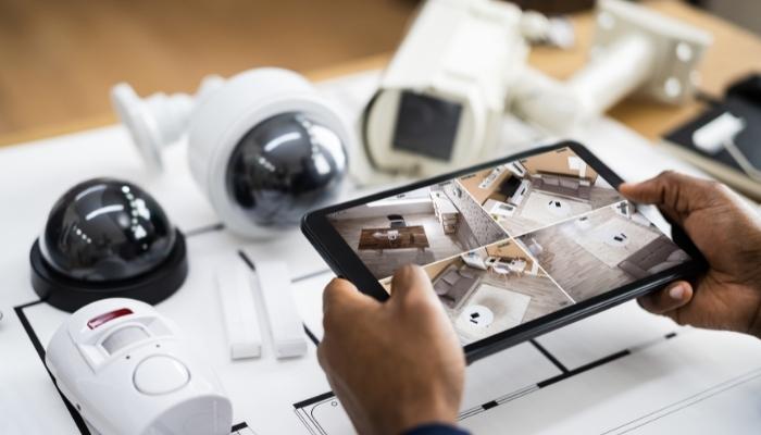 Tablet showing security feed with security objects on the table