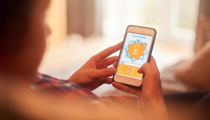 Hands holding phone with smart app
