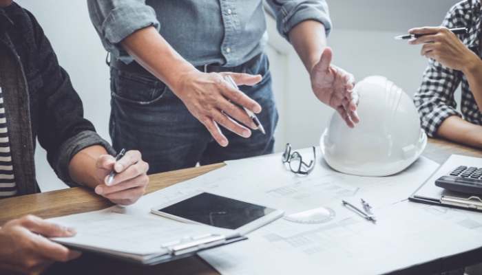 Contractors, architect, and custom integrator planning and measuring home