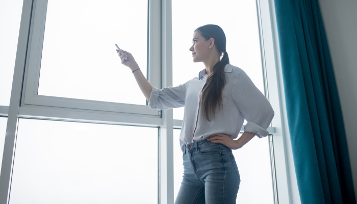 Woman controlling smart shades