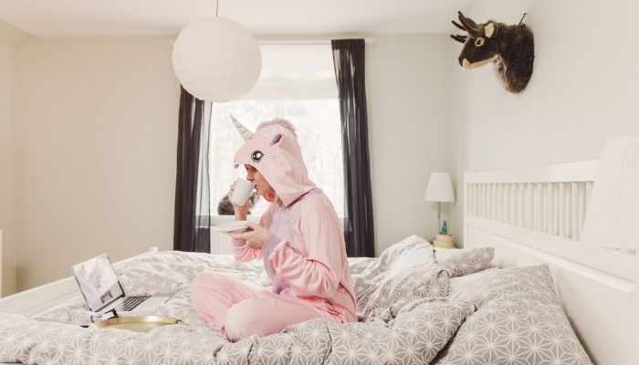 woman in unicorn costume in bedroom
