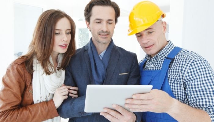 technician showing plans to couple on tablet
