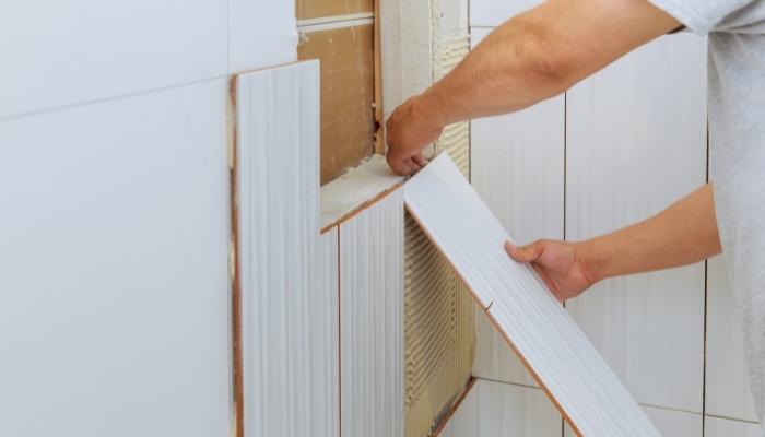 Hands installing drywall