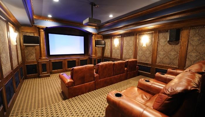 Home theater with speakers behind cabinet panels