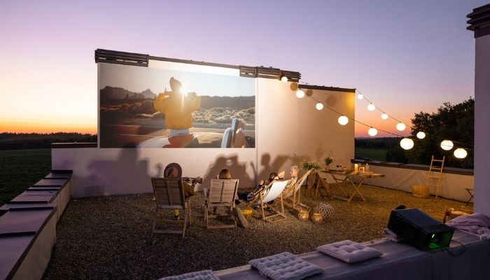 people sitting on patio watching movie