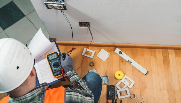 Professional doing a complex installation through the walls