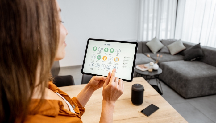 Closeup of woman using smart home control panel