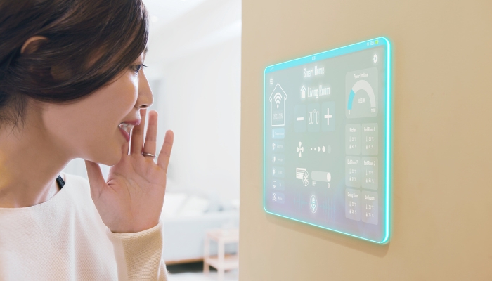 Woman talking to smart home control panel; futuristic concept
