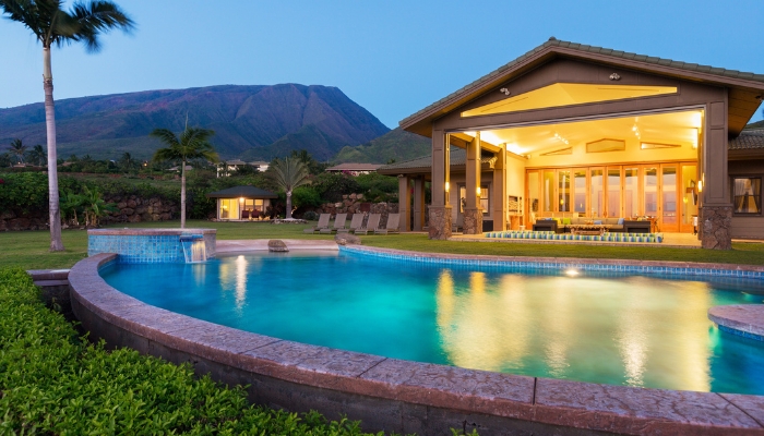 Luxury backyard with pool, lights, and comfy seating area