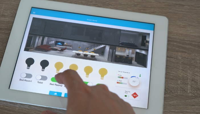 Closeup of someone turning off their smart lights with a control panel
