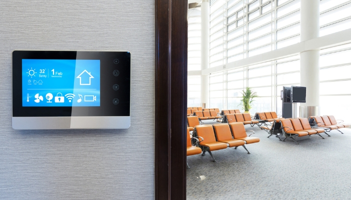 A control panel in front of an empty commercial space