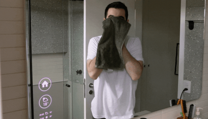 Man activating his coffee maker to start through smart mirror