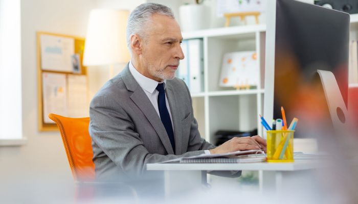 man working from computer in home office