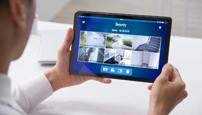Person monitoring their home security cameras