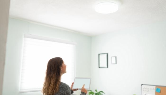 Woman adjusting smart lights