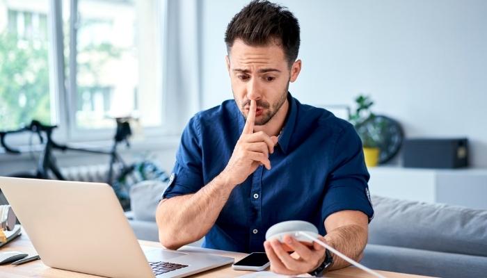 Man telling smart speaker to hush